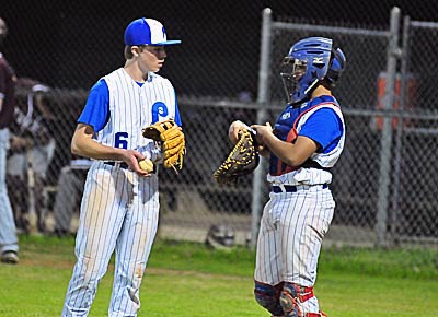 Polk County pitcher Tyler Harris and catcher Sedric Pickett talk strategy in the sixth inning of Tuesday's game.