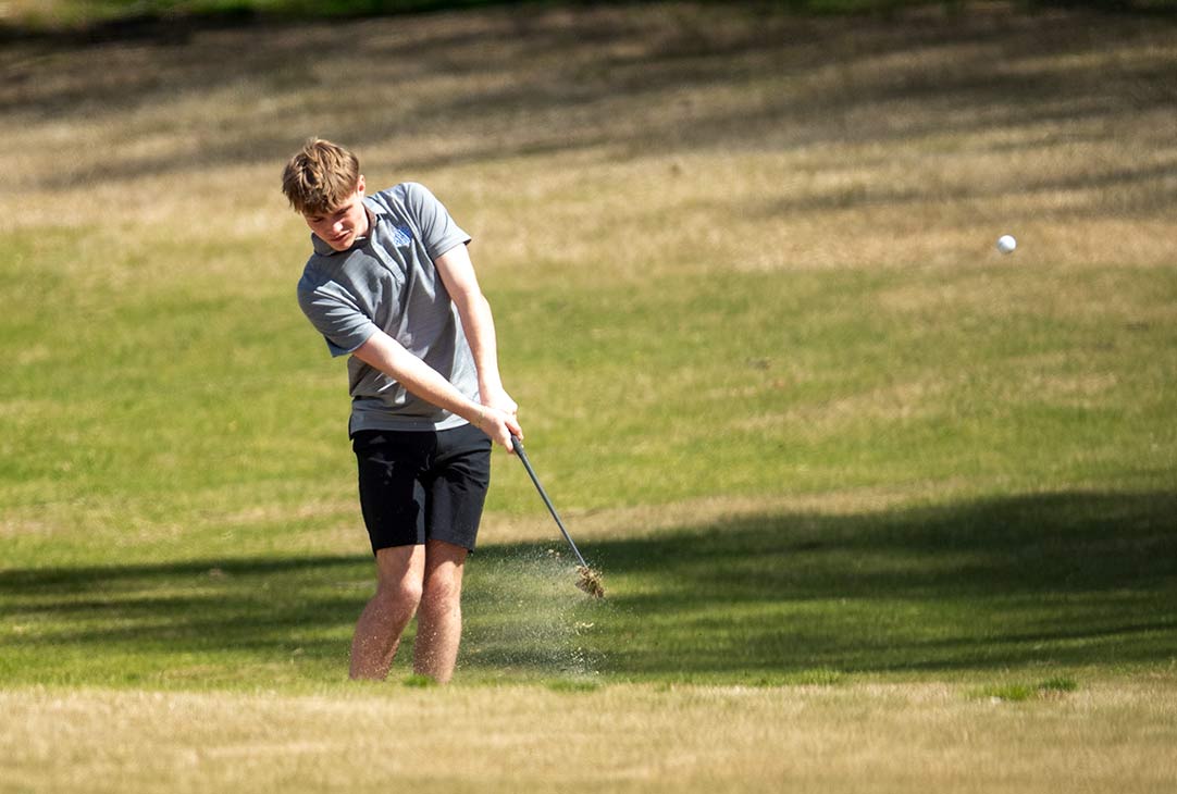 Polk County's Aiden Billings fires an approach shot Thursday at the fifth green at Tryon Country Club
